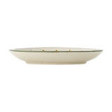 Side view of a cream stoneware Christmas plate from the Peo Star set of 4, showing a shallow rim with a thin green painted line, on a plain white background.