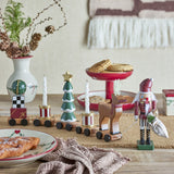Vadim Christmas Decoration wooden train with bauble, gift wagon, candle drums, snow-tipped tree and reindeer, styled on a table beside a nutcracker figure and festive décor.