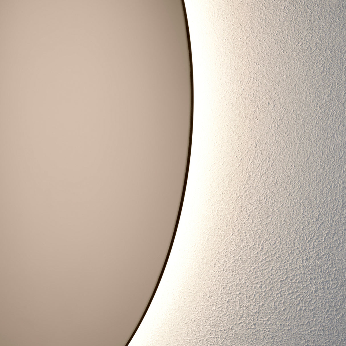 Close-up of the bronze glass edge with the warm light spilling onto the wall behind, showing how far the glass stands off it.