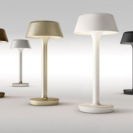 Firefly in the Sky rechargeable table lamp in Textured Soft White, with flared flat-topped shade, slim stem and round dish base, shown among other finishes on a plain grey background.