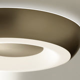 Close-up of the Superbold LED ceiling light's round dished body in brushed champagne, showing the glowing white ring around a brushed centre disc.