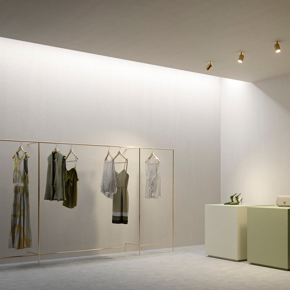 Carl Adjustable Recessed LED Downlight in Brushed Bronze, shown in a retail interior ceiling, with a small cylindrical adjustable head and round trim.