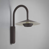 Fanalet A/02 aluminium outdoor wall light with tall arched arm and wide flat shade, graphite brown finish with white underside, shown against a plain light grey background.