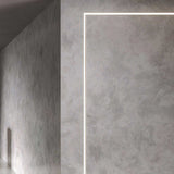 Bronx 300 recessed LED profile in black, forming a slim rectangular line of light along a textured grey wall corner.