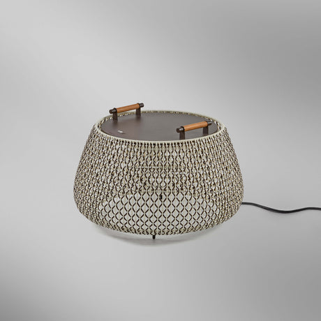 Nans Bag/38 Wood LED outdoor floor lamp with a round, drum-shaped brown woven cord shade, flat dark top, and two teak wood handles, shown on a plain light grey background.