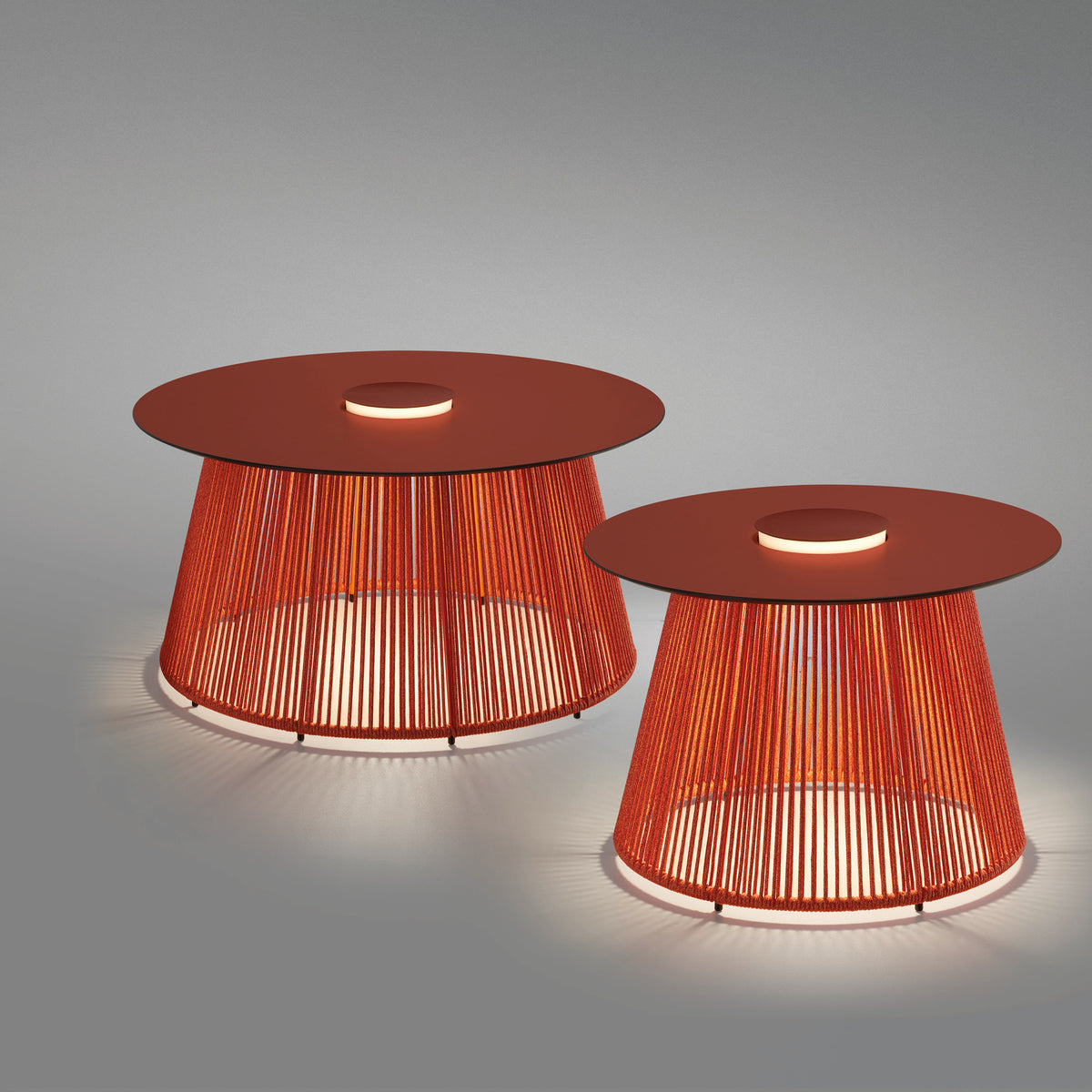Nit/80/R rechargeable outdoor table lamp, two sizes shown with round terracotta tops and orange woven cord bases, centred LED light rings glowing, on a grey background.