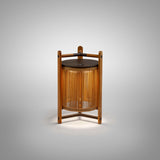Kando M/40/R rechargeable outdoor table lamp with sand nautical cord cylinder wrapped in a teak wood frame and dark metal top and arms, shown lit on a plain grey background.