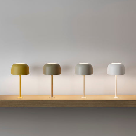 Bol M/33 Dome LED Table Lamp in Textured Olive Grey, shown third among four colour options with dome shade, slim stem and round base on a wooden shelf.