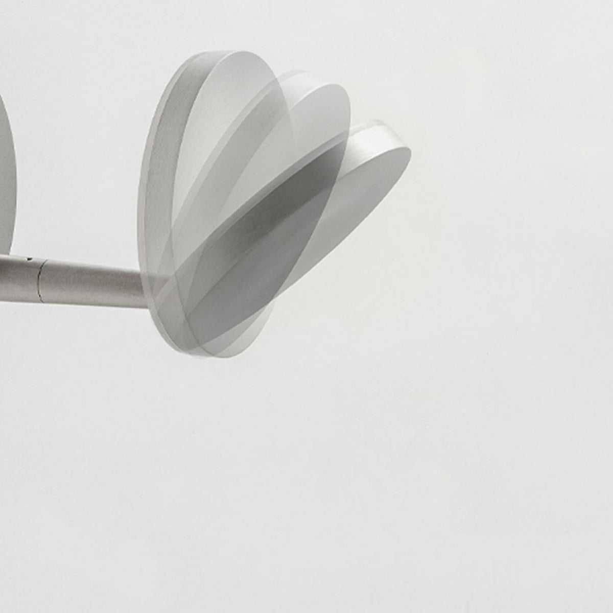 Bella Direct Aluminium LED wall light with round back plate, slim angled arm and flat disc head in brushed silver, shown against a plain white background.