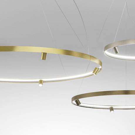 Brushed brass Arena Aluminium Ring LED Pendant Light, 147cm, a slim circular hoop with integrated LED band and spotlight heads, shown with a smaller champagne-toned ring pendant.