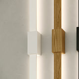 Bow Wall 300 lighting accessory in Wood Effect finish, slim vertical LED strip with square wood-toned fixing box, shown beside a white-finish version against a plain wall.
