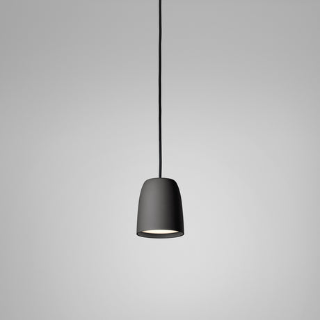 Nut S/10 pendant light with a small bell-shaped matte black shade on a black cord, shown against a plain light grey background.