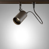 Spotlight Outrack aluminium outdoor track spotlight in brown, single cylindrical head with integrated LED, mounted on a track against a plain grey background.