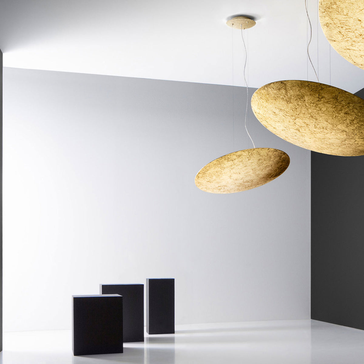 Gong Aluminium Disc LED Pendant Light 60cm in gold leaf finish, shown as flat round discs suspended on thin wires at different heights in a white interior setting.