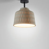 Soft PF/30 Bell outdoor ceiling light in Olive Grey, bell-shaped shade with raised diamond pattern, black stem and canopy, glowing base, shown on a plain light grey background.