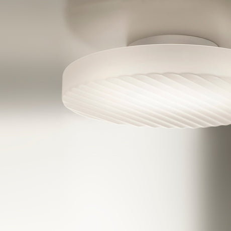 Côte 48cm ceiling light in frosted white glass with ribbed texture and white canopy mount, integrated LED glow visible, close-up on neutral background.