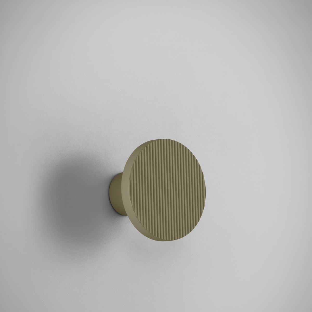 Arid A/01 round aluminium LED wall light with vertically fluted disc in Textured Olive Grey, mounted on a short wall-facing stem against a plain light grey background.