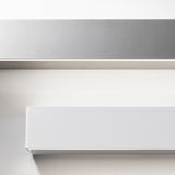 Close-up of the Toy S LED Wall Light 57.7cm in White, a slim rectangular bar with crisp corners and a flat face, shown above a brushed metal bar on a plain light background.