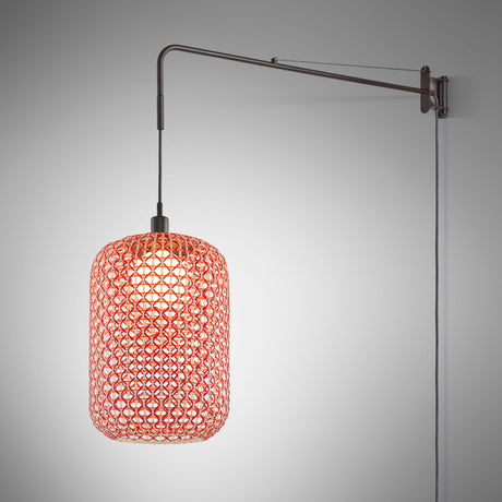 Nans 31.2 A/98 plug-in wall light with a woven red and beige cylinder shade suspended from a long brown swing arm, shown on a plain grey background.