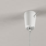Ceiling-mounted fixing for steel wire lighting, white tapered body with chrome ring and hook, suspension cable hanging below, on a plain light grey background.