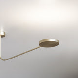 Dip Disc LED ceiling light in Brushed Champagne, with a round disc head on a curved slim arm extending from a small ceiling mount, shown against a plain light background.
