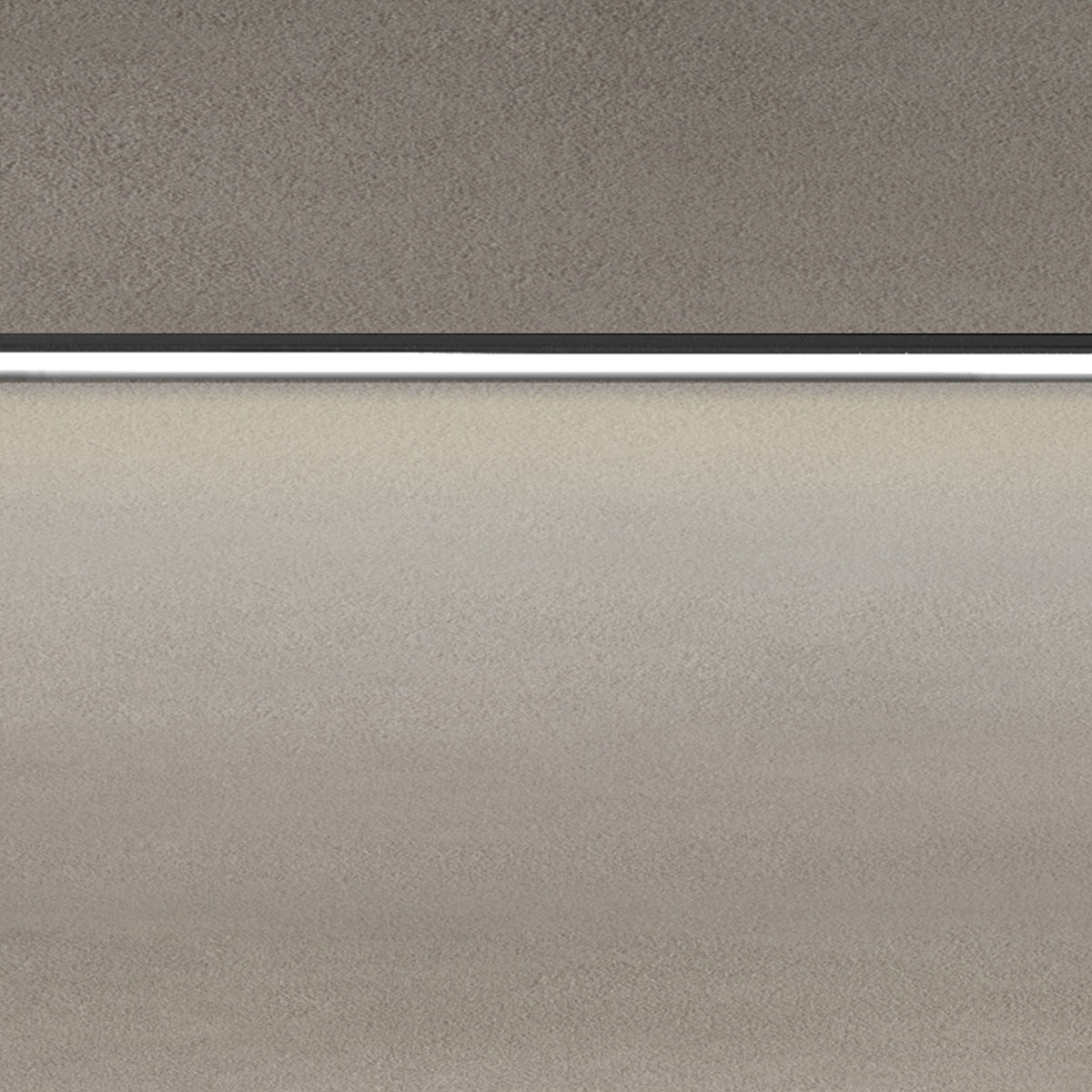 Close-up of the Street Line Linear LED Track Spotlight in black, showing the slim bar and continuous white diffuser strip emitting warm light beneath a ceiling surface.