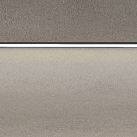 Close-up of the Street Line Linear LED Track Spotlight in black, showing the slim bar and continuous white diffuser strip emitting warm light beneath a ceiling surface.