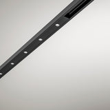 Close-up of the Street Spot Linear LED Track Spotlight in black, a slim diagonal profile with a row of round light openings and visible fixing screws on a plain light grey background.