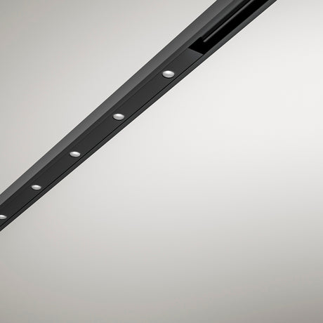 Close-up of the Street Spot Linear LED Track Spotlight in black, a slim diagonal profile with a row of round light openings and visible fixing screws on a plain light grey background.
