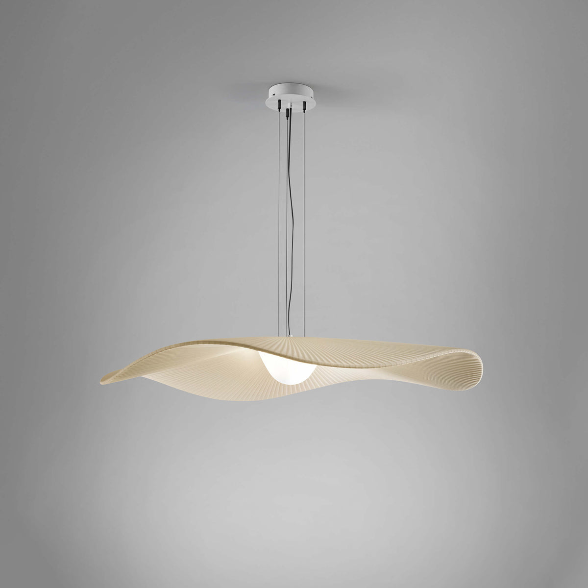 Mediterrània S/105 Ribbon LED pendant light with a wide, pleated cream translucent shade curving in a soft wave, suspended from a white ceiling canopy against a plain grey background.