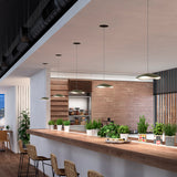 Valentina S/24 LED pendant lights with wavy olive grey and white leaf-shaped shades, shown in multiple heights above a wooden kitchen island with potted herbs.