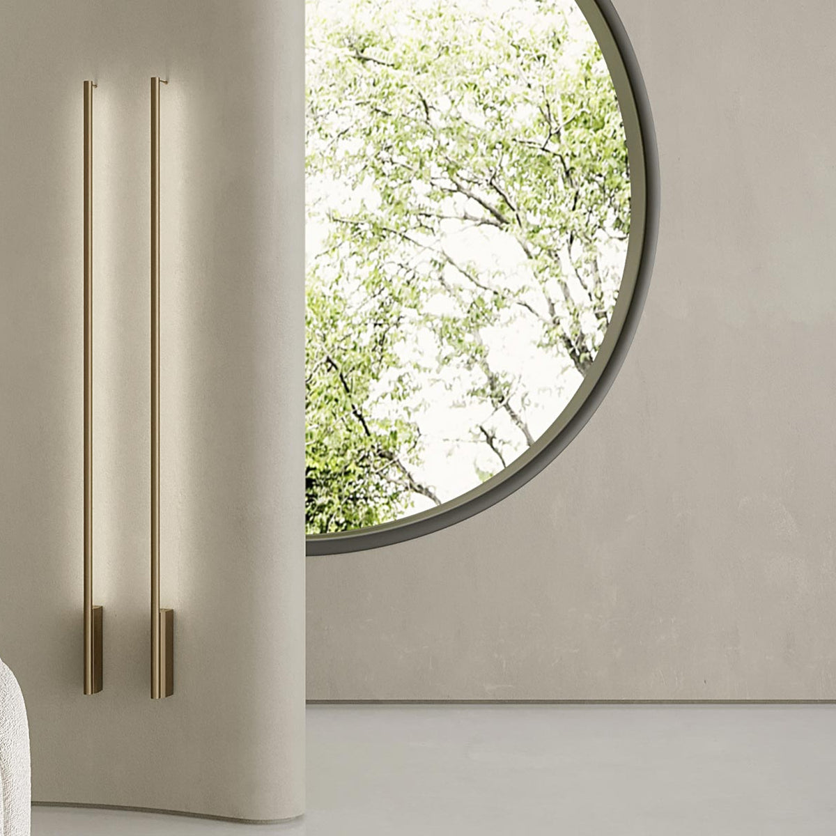 Hilow Line linear wall lights in Brushed Champagne, two slim vertical rods with rectangular foot brackets mounted on a plaster wall beside a round window.