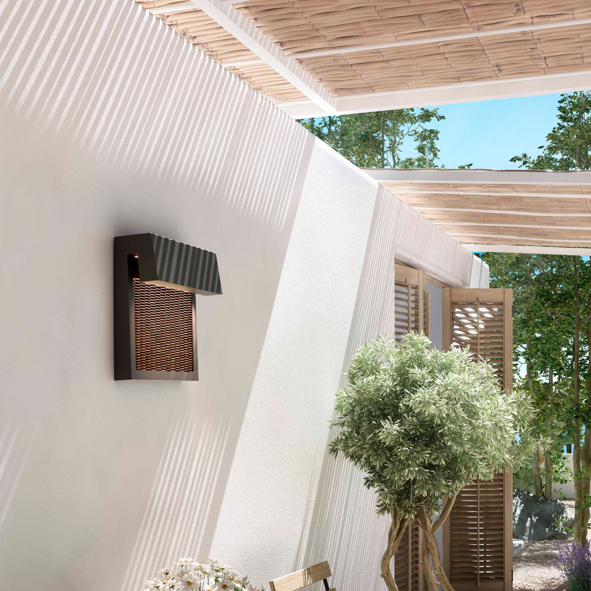 Sisal A/01 LED outdoor wall light with angular brown body, overhanging top and woven light beige fibre front, mounted on an exterior wall beneath a pergola.