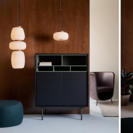 Misko S25 glass drum pendant light with a ribbed white shade and black collar, shown lit beside a three-tier version against a wood-panelled wall.