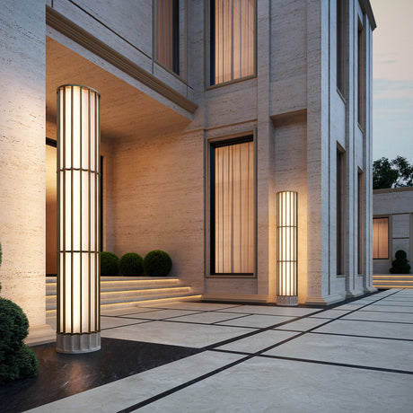 Roma Glass LED Outdoor Floor Lamp 186cm in Brushed Bronze, a tall three-tier column with vertical bars and white glass, illuminated beside a stone building entrance.