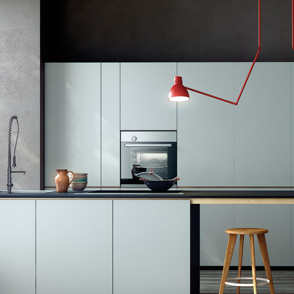 Blux C Aluminium Dome Ceiling Light in red, shown in a kitchen with a zig-zag stem and angled arms positioning the dome shade beside a wall oven.