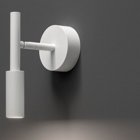 Tubino Aluminium LED Wall Light in white, a slim tube fixture on an adjustable arm from a round wall plate, shown against a dark grey background.