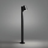 Nut B/90 Bell LED bollard light in textured black, with a bell-shaped head angled atop a slim square post and round base plate, shown against a plain grey background.