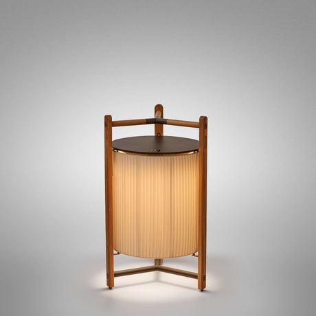 Kando P/76/R rechargeable LED floor lamp with cream pleated ribbon shade in a three-legged teak wood frame and dark round top, on a plain grey background.