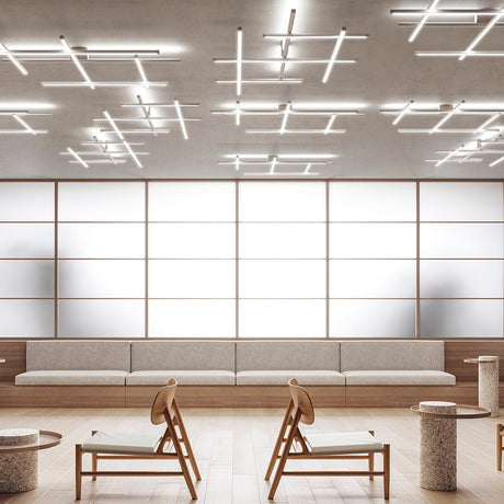 Hilow LED ceiling light with brushed titanium bars and black diffuser frames arranged in a crossing grid, installed above a lounge seating area.