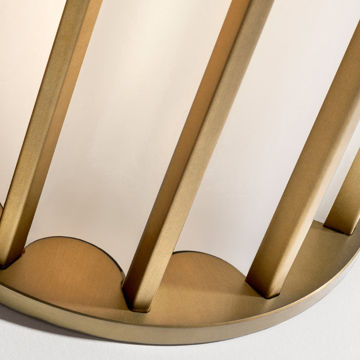 Close-up of the Roma Glass LED Table Lamp in Brushed Bronze, showing slim vertical metal bars over white glass panels and a scalloped base.