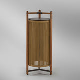 Kando P/111/R rechargeable outdoor floor lamp with teak wood frame, sand nautical cord cylinder shade, brown top disc and three-legged base, on a plain white background.