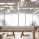 Hilow White Diffuser Frame LED ceiling light with multiple linear fixtures arranged in crossed grid patterns on a concrete ceiling above a modern seating area.