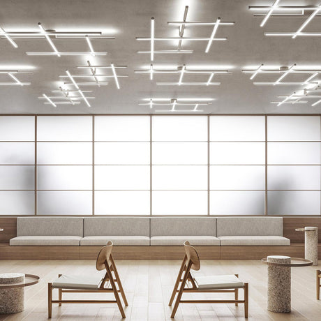 Hilow White Diffuser Frame LED ceiling light with multiple linear fixtures arranged in crossed grid patterns on a concrete ceiling above a modern seating area.