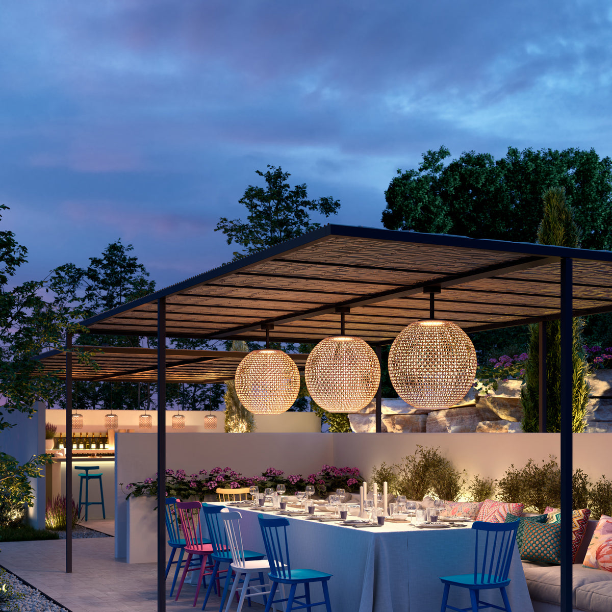 Three large woven sphere pendant lights in beige hang from a dark pergola over an outdoor dining table set for evening entertaining.