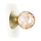 Murané wall light with a 10cm rippled pink glass sphere on a brushed champagne dome backplate, shown against a plain white background.