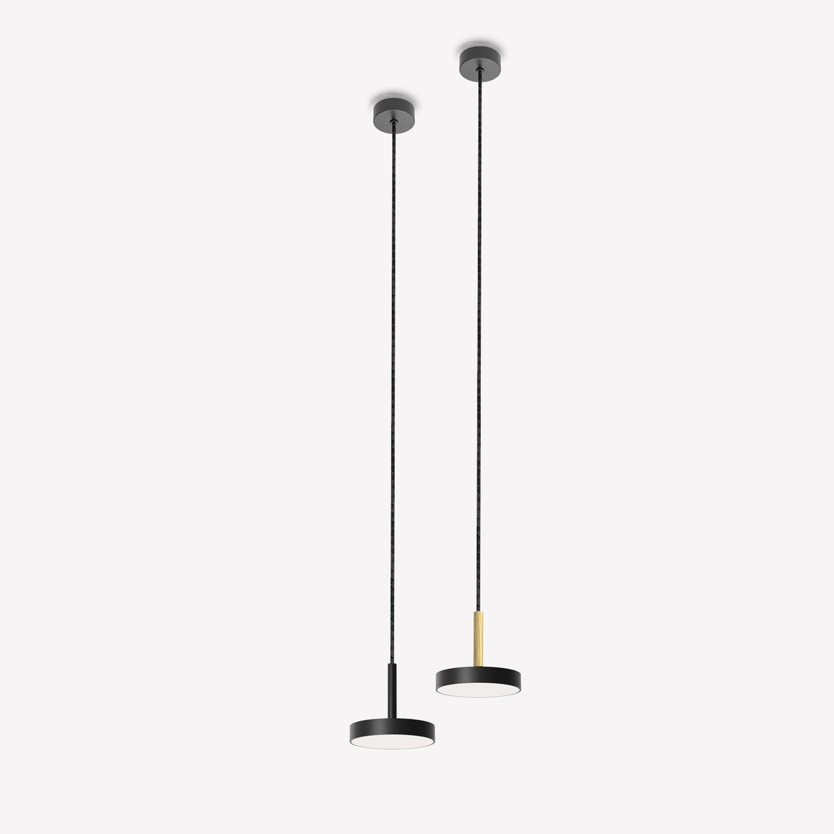 Two matt black LED drum pendant lights with slim stems on long cords, one with a brass-tone accent, shown against a plain white background.