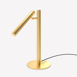 Rui LED Adjustable Reading Table Lamp in gold, with a slim tubular shade on a pivoting joint atop a straight stem and round flat base, set against a plain white background.
