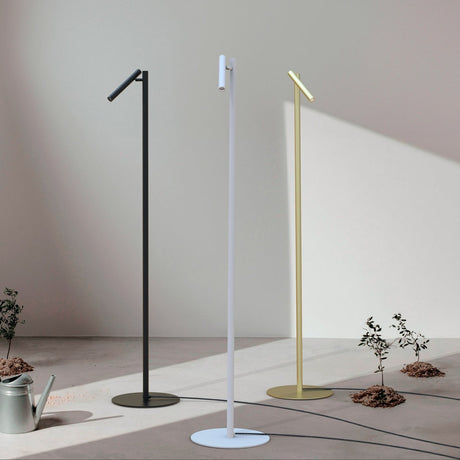 Rui LED Reading Floor Lamp in matt white, slim pole on round disc base with pivoting tubular shade, shown alongside black and brass versions in a sunlit room.