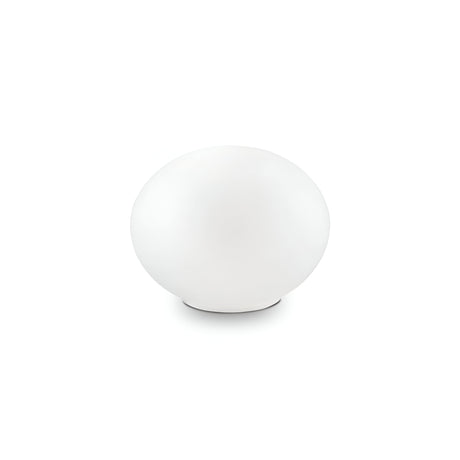 At the center of the Orlix Small Table Lamp - White, a round, smooth egg-shaped object with a matte finish is elegantly positioned against a simple white background.